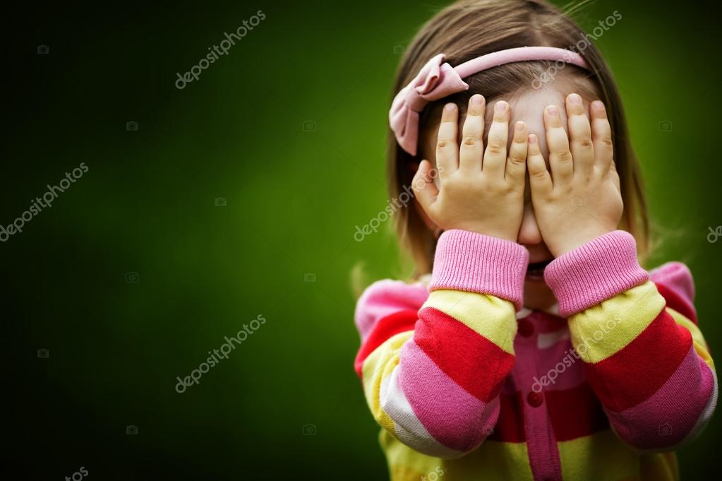 Little girl is playing hideandseek hiding face ⬇ Stock Photo, Image