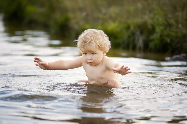 Little funny boy playing in water — Stock Photo, Image