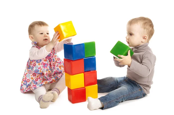Boy and girl playing with cubes Stock Photo