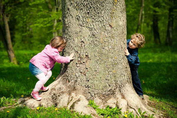 Girl and boy playing hide and seek