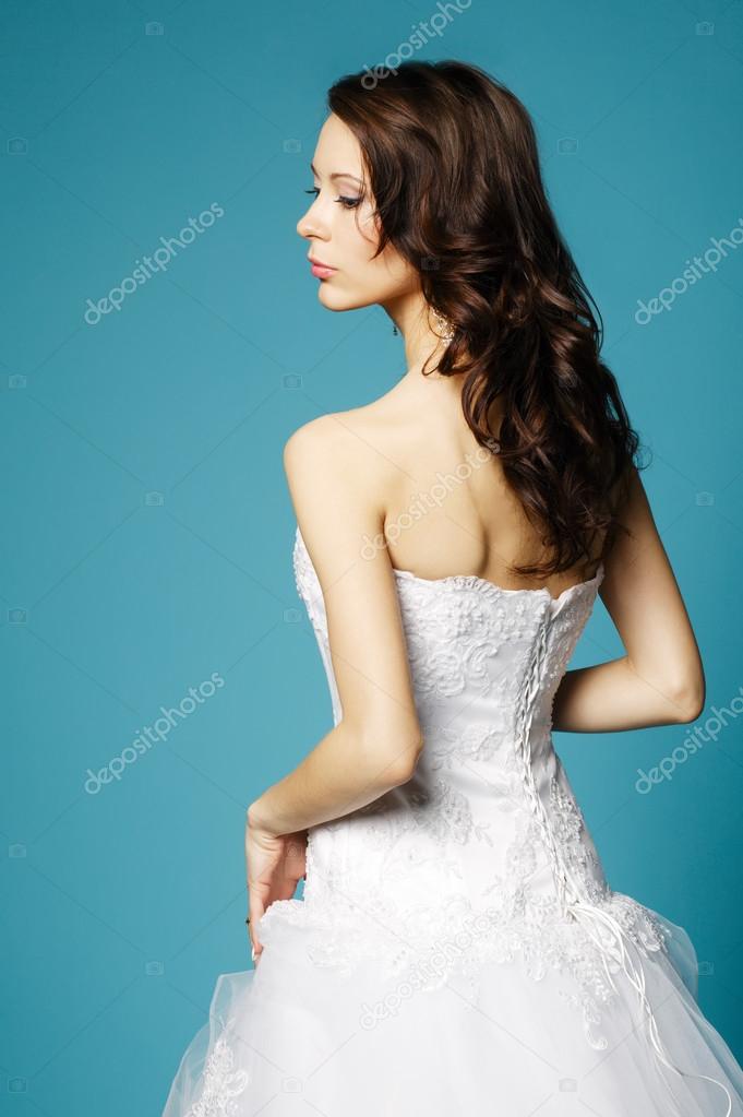 beautiful girl in wedding dress on blue background