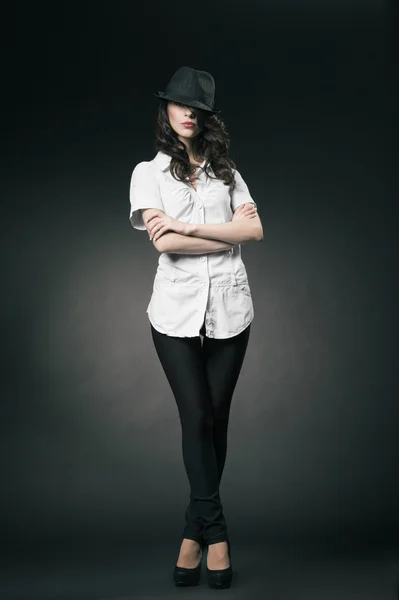 Beautiful brunette girl with black classic hat — Stock Photo, Image