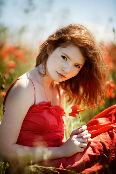 Young beautiful girl in poppy field — Stock Photo, Image