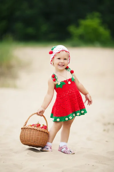 Little girl with basket full of strawberries — Stock Photo, Image
