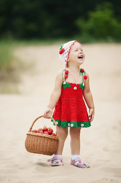 Little girl with basket full of strawberries — Stock Photo, Image