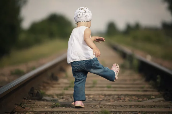 Little girl plays on railroad — Stock Photo, Image