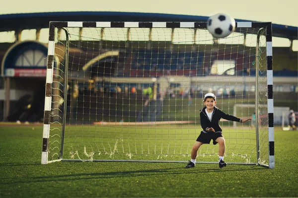 Little boy plays football