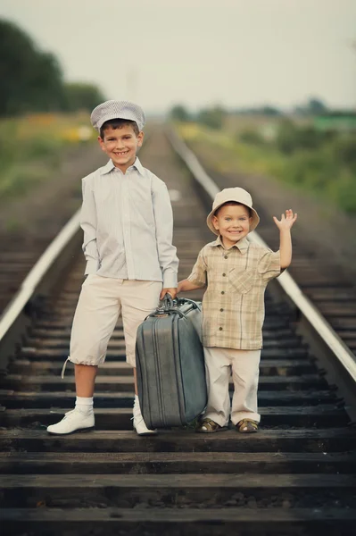 Pojkar med resväska på järnvägar — Stockfoto