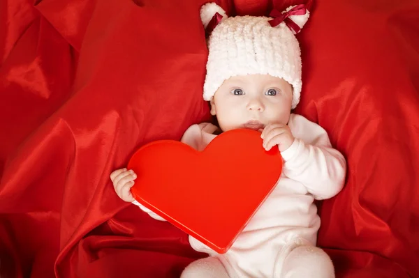Cute little baby with heart Stock Image