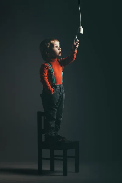 Cute little boy with bulb — Stock Photo, Image