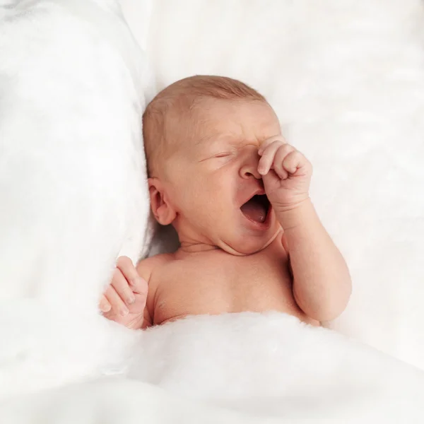 Portrait of a cute little newborn baby yawning — Stock Photo, Image