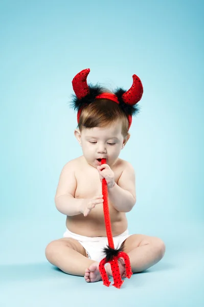 Baby with devil horns on blue background — Stock Photo, Image