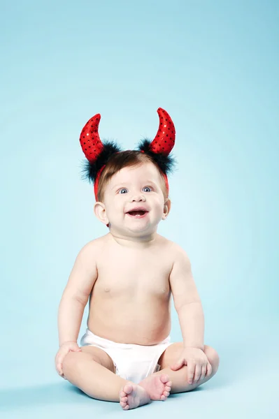 Baby with devil horns on blue background — Stock Photo, Image