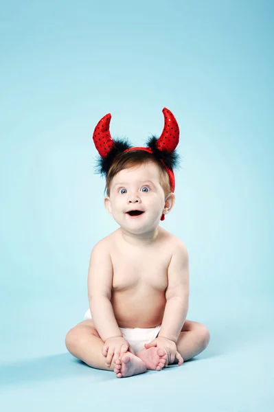 Baby with devil horns on blue background — Stock Photo, Image