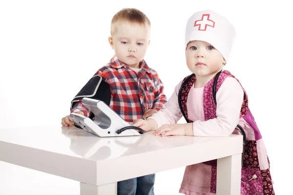 Boy and girl playing with tonometer — Stock Photo, Image