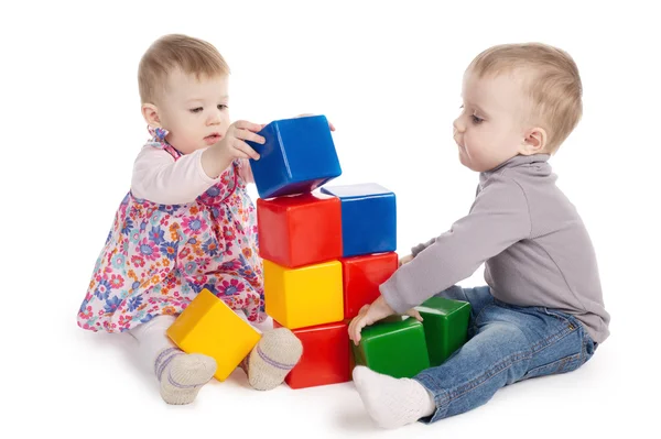 Boy and girl playing with cubes Royalty Free Stock Photos