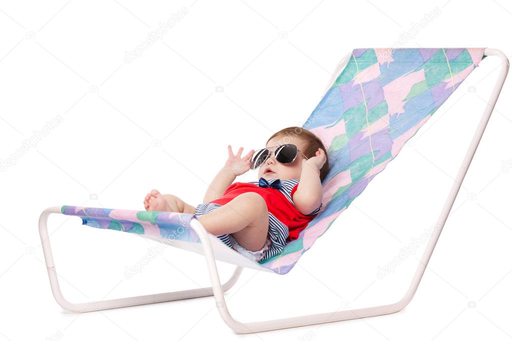 baby lying on lounger isolated on white