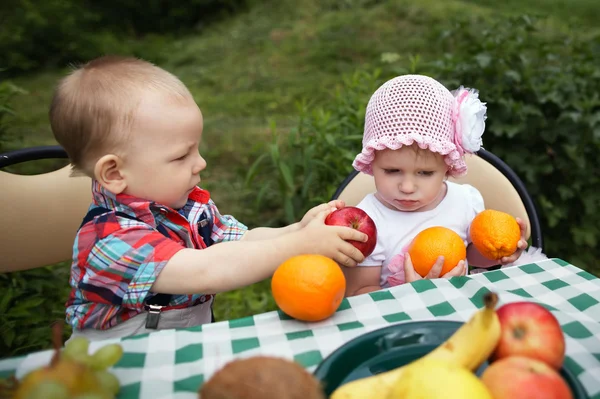 Boy and girl on picnic in park — Stock Photo, Image