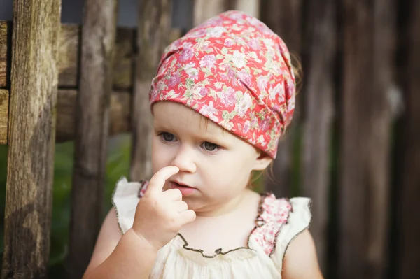 Little girl with finger in her nose — Stock Photo, Image