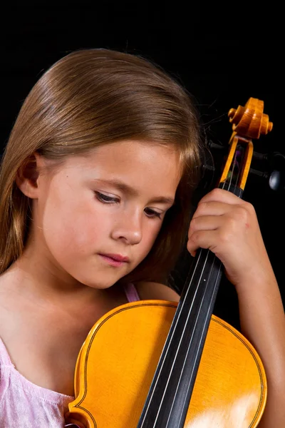 Girl holding violin in pink dress — Stock Photo, Image