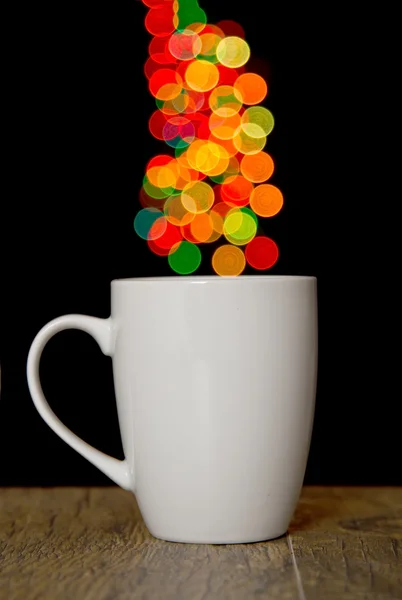 Bokeh round spots of lights on background cup on wood — Stock Photo, Image