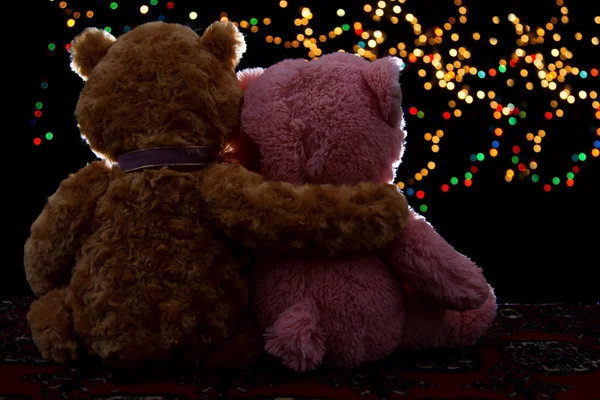 Two Teddie bear sitting holding bokeh background — Stock Photo, Image