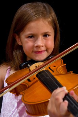 Girl playing violin in pink dress