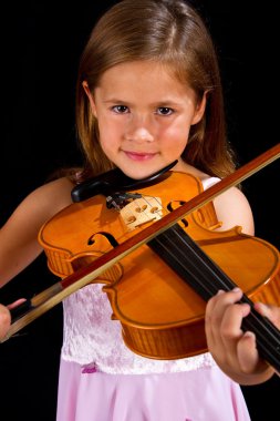 Girl playing violin in pink dress