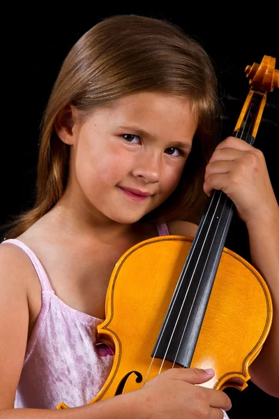 Girl holding violin in pink dress — Stock Photo, Image