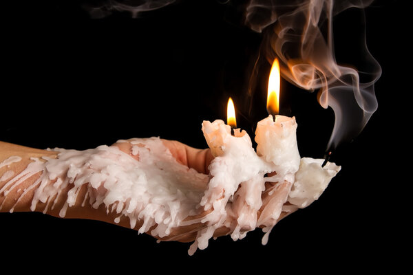 Three candle sticks on fingers buring