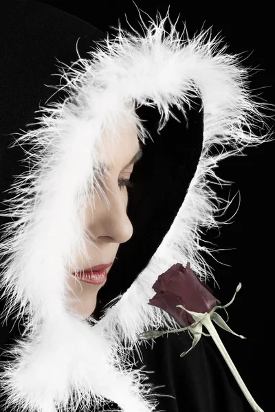 Portrait of sad woman in black cape and rose artistic conversion — Stock Photo, Image