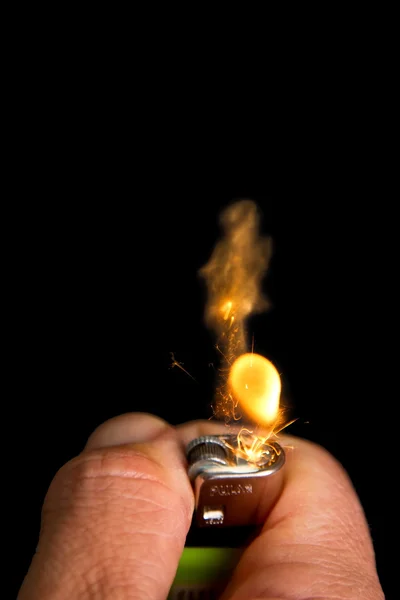 Hand with lighter igniting sparks — Stock Photo, Image