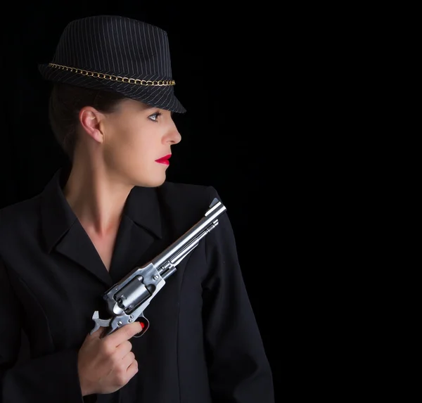 Dangerous woman in black with silver handgun — Stock Photo, Image