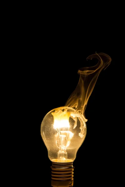 Broken light bulb burn out with flame — Stock Photo, Image