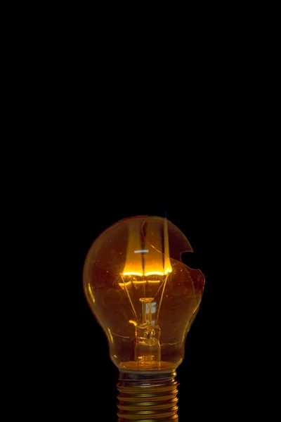 Broken light bulb burn out with flame — Stock Photo, Image