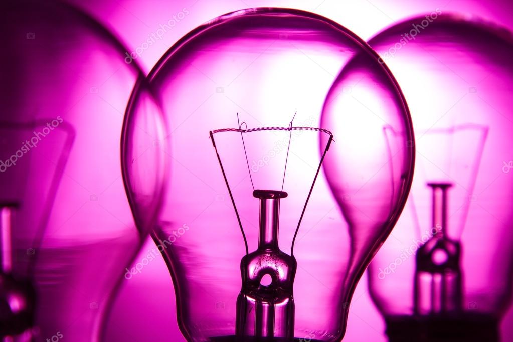 Row of light bulbs on a bright pink background