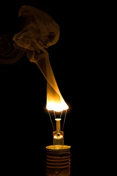 Broken light bulb burn out with flame — Stock Photo, Image