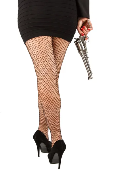 Legs of dangerous woman with handgun and black shoes — Stock Photo, Image