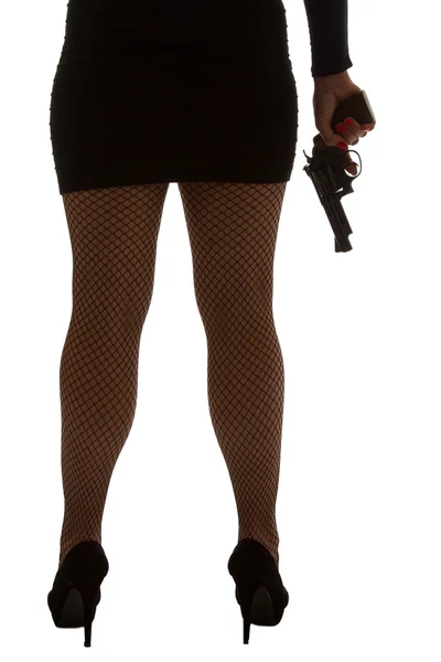 Legs of dangerous woman with handgun and black shoes silhouette — Stock Photo, Image