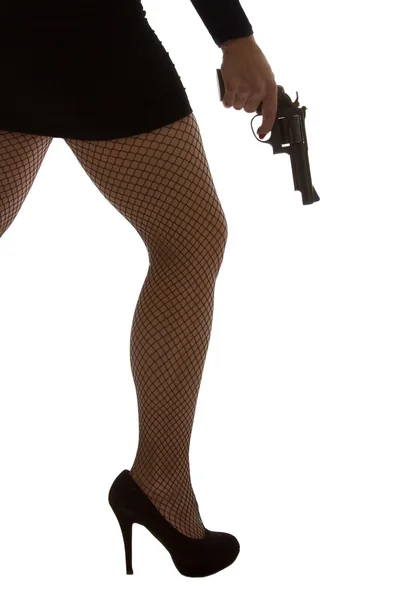 Legs of dangerous woman with handgun and black shoes silhouette — Stock Photo, Image