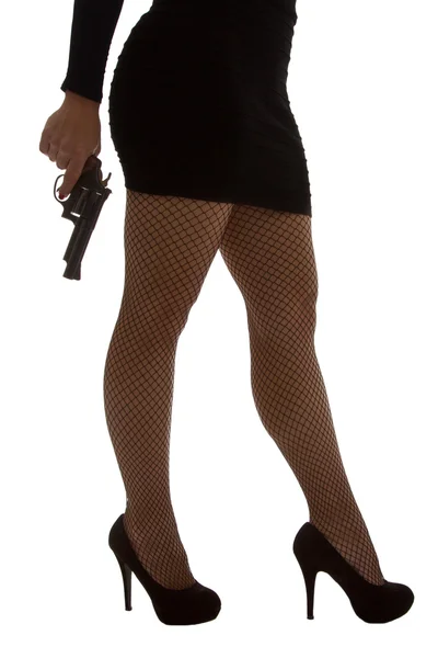 Legs of dangerous woman with handgun and black shoes — Stock Photo, Image