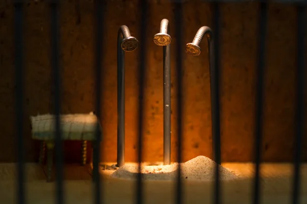 Conceptual jail photo with iron nail escaping behind out of focu — Stock Photo, Image