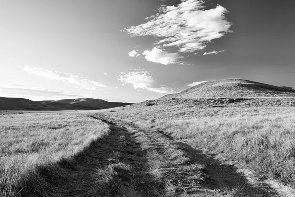 Mountain landscape with road and dramatic clouds artistic conver — Stock Photo, Image