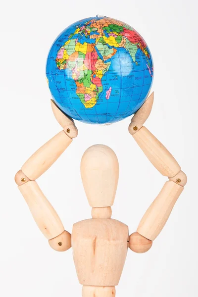 Brown wood mannequin holding concerned a globe protect — Stock Photo, Image