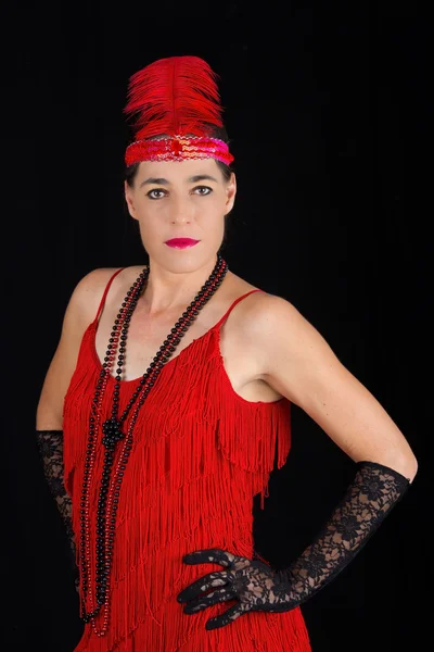 Young beautiful brunette in 1920 style attire red dress and a fe — Stock Photo, Image