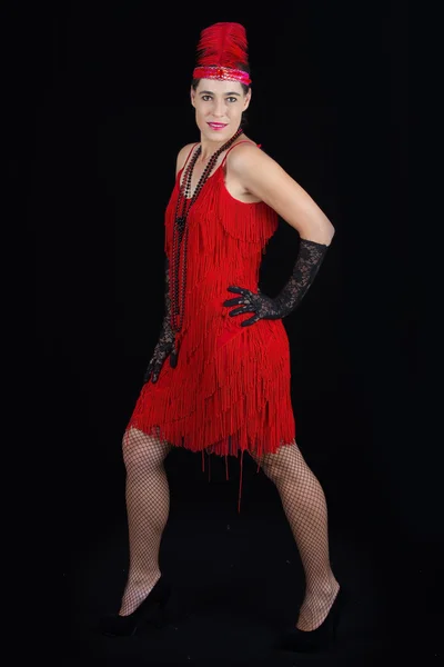 Young beautiful brunette in 1920 style attire red dress and a fe — Stock Photo, Image