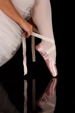 Ballerina put on slippers to prepare for performance with reflec clipart