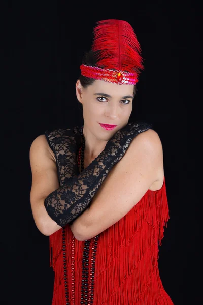 Young beautiful brunette in 1920 style attire red dress and a fe — Stock Photo, Image