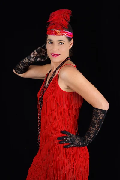 Young beautiful brunette in 1920 style attire red dress and a fe — Stock Photo, Image