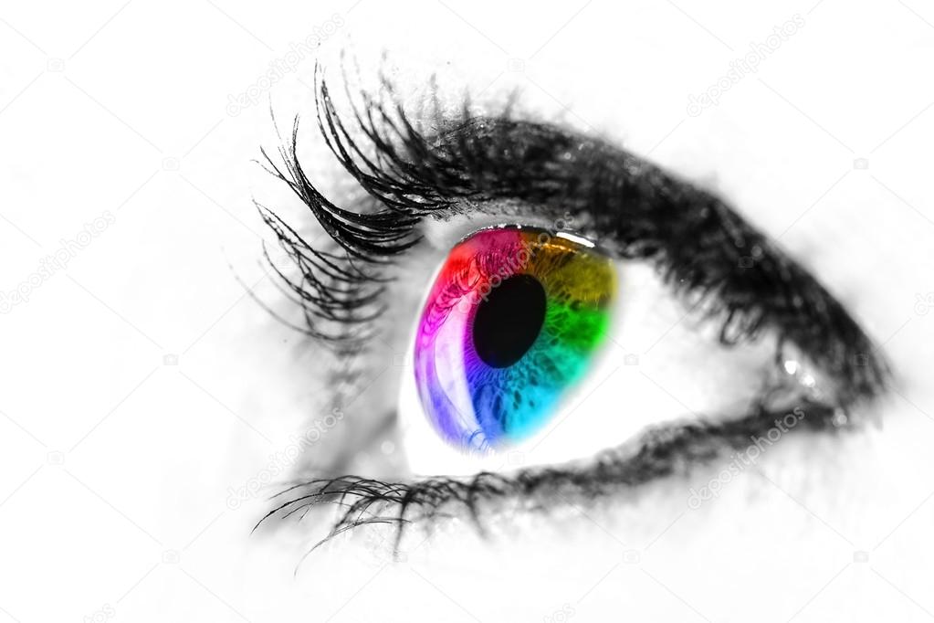 Eye macro in high key black and white with colourful rainbow in 